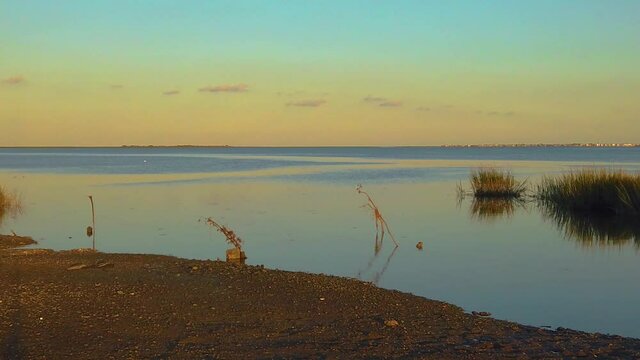 HD 120 fps pan left to right from waterway view to reveal Atlantic City skyline with mostly clear sky near golden hour