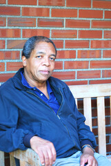 African american male sitting outside.