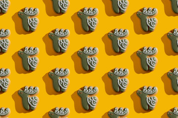 Green deer seamless pattern. Yellow art background. Cute symmetrical ornament poster for kids. Creative abstract animal figure design isolated on bright orange.