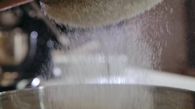 Close-up Flour Sifting with Sieve for Bread and Pastry Making. Conception Cooking Dough with Baker in Home Menu. Chef Confectioner Sift Powdered Flour or Sugar in Sieve on Bakery Background Slow mo 4k