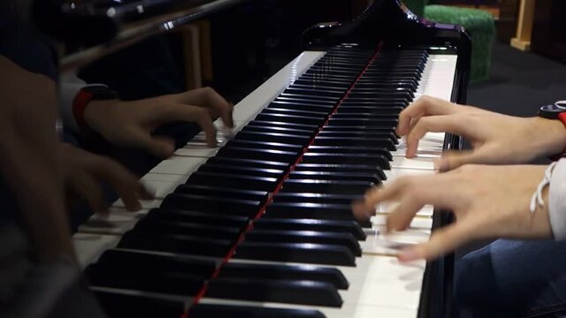 Professional pianist. The pianist performs playing a grand piano. Hands close up.	
