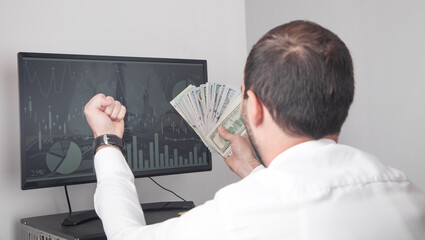 Fototapeta na wymiar Man showing money in computer screen.
