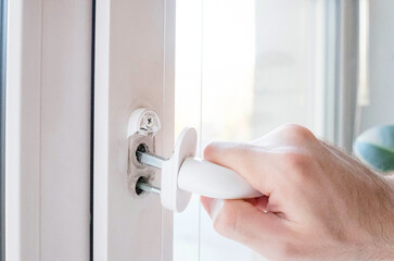 The window handle is broken. Hold the mechanism in hand