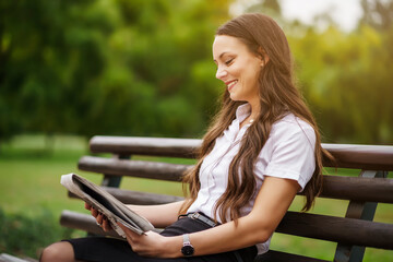 Businesswoman is relaxing on break. She is reading newspapers.