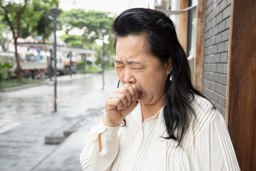 Fototapeta na wymiar sick allergic senior woman coughing with cold, flu or coronavirus infection, COVID-19 symptom