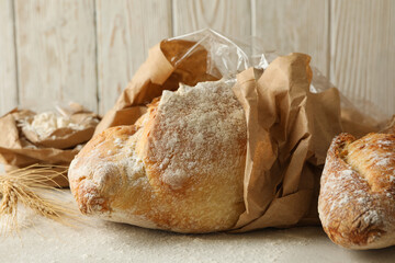 Fresh baked bread and flour on white background