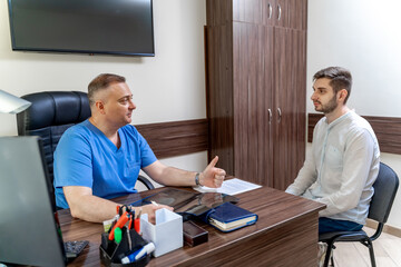 Male doctor and patient discussing methods of health issues treatment. Health care concept.