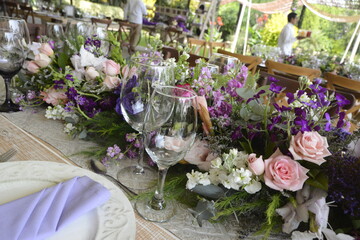 Table prepared for a wedding with purple flowers