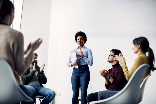 African American Female Psychotherapist Getting Applause After Successful Group Therapy.