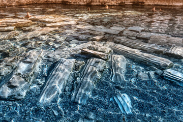 The ancient pool with thermal springs and remains of columns and other archaeological finds is a...
