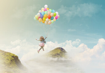 Little girl holding colorful balloons, jumping from one mountain top to the other; success/achievement concept, fantasy background with copy space - obrazy, fototapety, plakaty