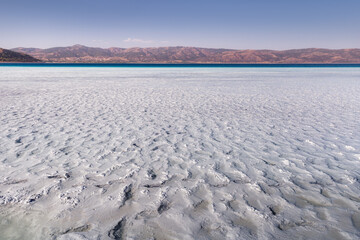 Mud baths and silt in the water of a lake Salda in Turkey. Concept of river shallowing or...