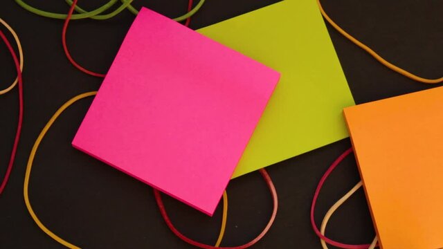Hand taking one post-it note from a block