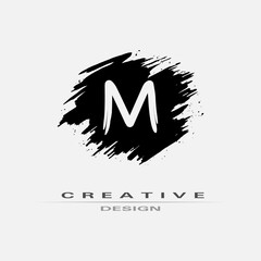 Letter M Logo With Brush Stroke and Splatter Elements. Handwritten Brush Stroke letter M logo design. Creative template suitable for company, logotype, emblem, monogram, jewelry, cosmetic, brand name.
