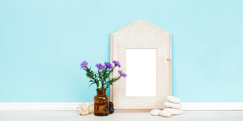 Banner mockup template with rustic vertical wooden  blank picture frame, and decoration in front of light blue wall. Blank image area isolated with clipping path.