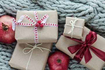 Christmas presents and boxes on gray knitted cozy background 