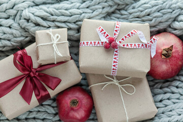 Christmas presents and boxes on gray knitted cozy background 