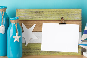 Summer holidays greeting card mockup on rustic wooden clipboard with maritime decoration. Blank area isolated with clipping path.
