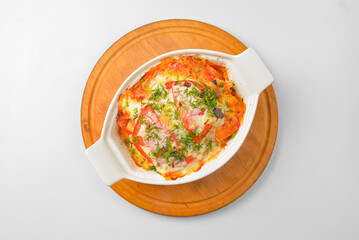 Italian lasagna served in a white pot over white background. Delicioud dinner concept, Italian cuisine.