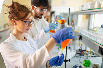 Group of medical research scientists collectively working in laboratory