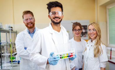 Group of medical research scientists collectively working in laboratory