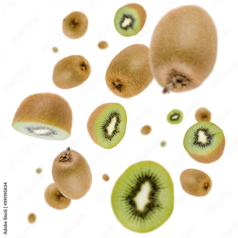 Wall mural Many free falling kiwi fruits on white background. Selective focus - shallow depth of field.