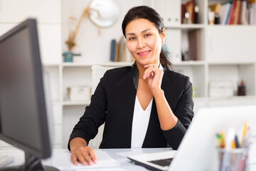 Portrait of successful business woman in modern office interior