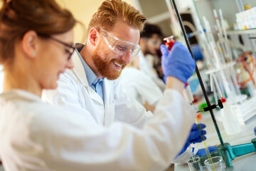 Young scientists, students of chemistry working in laboratory