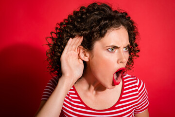 Photo of shocked curly young lady wear casual striped outfit arm ear listening disgusting rumors...