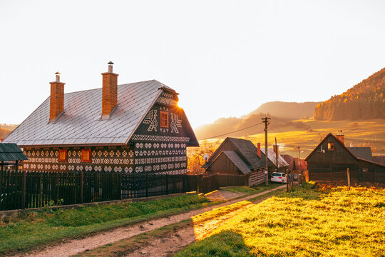 Old wooden houses in Slovakia village Cicmany in autumn. Unique decoration of log houses based on patterns used in traditional embroidery in village of Cicmany, UNESCO World Heritage Site, Slovakia