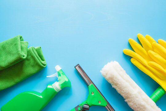 Professional Cleaning Set For Window, Mirror Or Other Glass Surfaces Washing. Empty Place For Text Or Logo On Blue Table Background. Early Spring Regular Cleanup. Top Down View. Closeup.