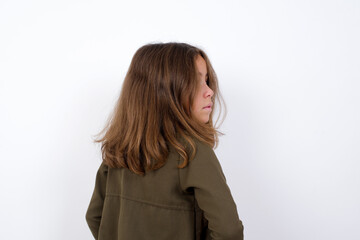 The back view of Beautiful little girl standing against white background, Studio Shoot.