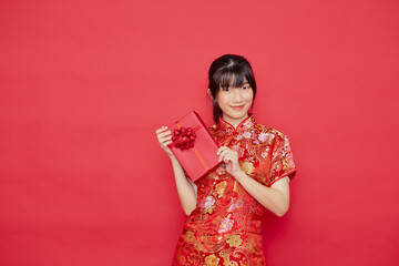 Portrait young Asian woman wear Chinese dress red