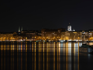 Fototapeta na wymiar Illuminated Helsinki waterfront with Helsinki Cathedral in the background.