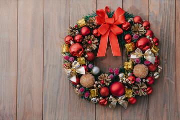 Christmas wreath on wooden background. Christmas decor handmade. Top view
