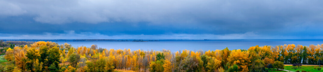 Autumn landscape. Golden autumn. View of the forest and the river. Panoramic view.