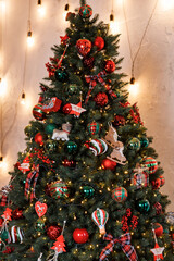 Beautiful festive Christmas tree is in the room decorated with Christmas toys balls