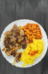 View from above on young fresh potatoes with meat and white beans
