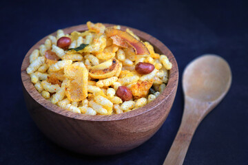 Murmura cornflakes Chivda or Chiwada. Diwali special savory snack mixture, made out of puffed rice, fried peanuts, curry leaves, and some spices. Traditional Indian Diwali Snacks. with Copy Space.