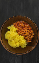 View from above on fresh mashed potatoes with white beans in a glass plate