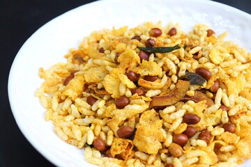 Murmura cornflakes Chivda or Chiwada. Diwali special savory snack mixture, made out of puffed rice, fried peanuts, curry leaves, and some spices. Traditional Indian Diwali Snacks. with Copy Space.