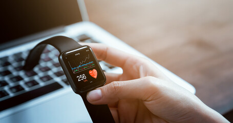 Close up of hand touching smartwatch with health app on the screen, gadget for fitness active lifestyle.