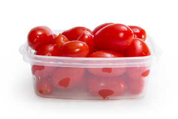Washed red plum tomatoes in the plastic container