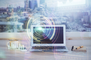 Double exposure of desktop computer and technology theme hologram. Concept of software development.