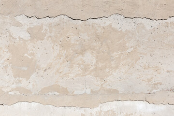 Old concrete wall with cracks and crumbling plaster, background