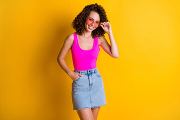 Portrait of her she nice attractive lovely cheerful cheery fashionable slender wavy-haired girl touching specs posing free time isolated on bright vivid shine vibrant yellow color background