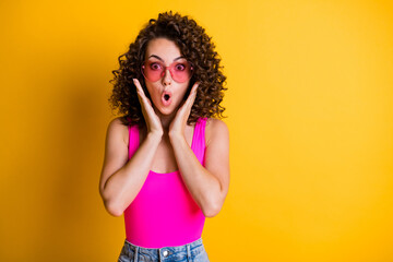 Photo of pretty crazy shocked wavy hairdo lady summer holidays black friday shopping prices open mouth not believe eyes wear heart shape sun glasses tank top isolated yellow color background
