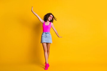 Full length body size view of her she nice attractive lovely pretty careless glad cheerful wavy-haired girl walking having fun vacation isolated on bright vivid shine vibrant yellow color background