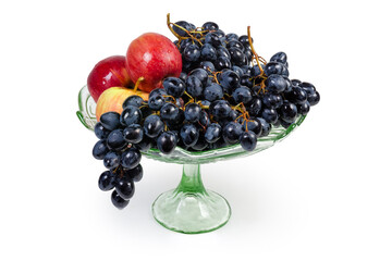 Washed blue grapes and apples in vintage glass fruits vase