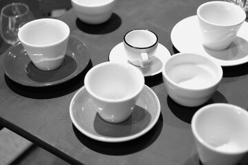 Empty cups on the table. Tea set. Black and white photo.